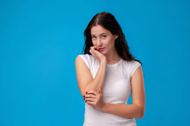 istock Thoughtful attractive young woman thinking on blue background 1150517863