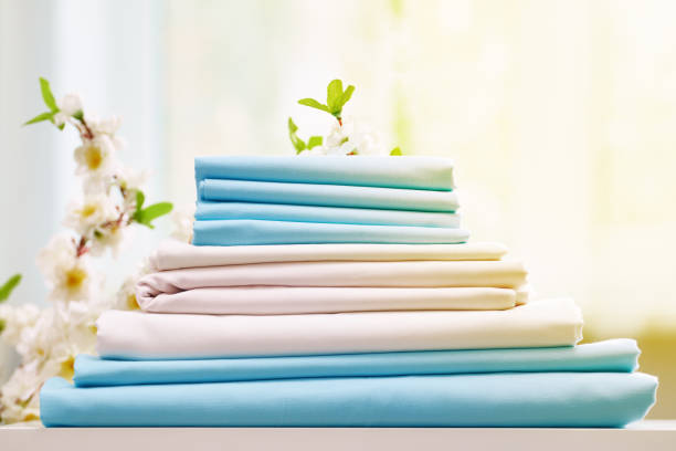 istock Closeup stack of blue and white clean bedding on the table. Blurred background. 1150518037