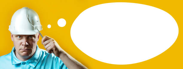 istock brutal man Builder in a white helmet on a yellow background 1150518312
