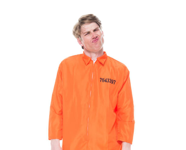 istock Male prisoner wearing orange jumpsuit 1150518682