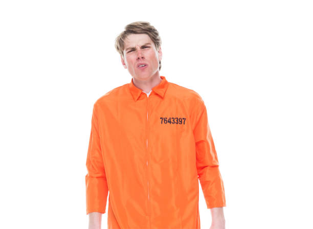 istock Male prisoner wearing orange jumpsuit 1150518702