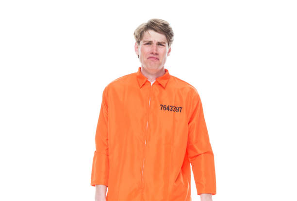 istock Male prisoner wearing orange jumpsuit 1150518719