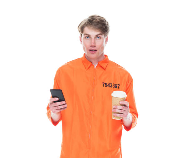 istock Male prisoner wearing orange jumpsuit 1150518743