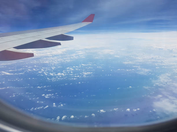 istock Clouds and sky as seen through window of an aircraft. 1150519592