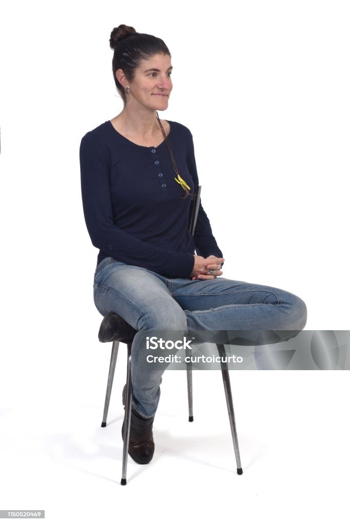 portrait of a woman on white background woman sitting in a vintage chair isolated on white Adult Stock Photo