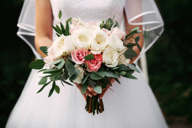 istock Bride holding bouquet of white roses. 1150520703