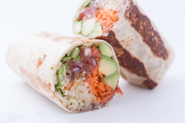 istock Burrito with avocado slices, bean paste, mexican rice, salsa, green salad, grated carrots 1150520961