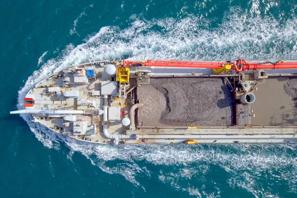 istock Red Trailing Suction Hopper-Dredger ship roaring across the sea 1150523019