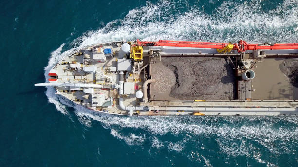 istock Red Trailing Suction Hopper-Dredger ship roaring across the sea 1150523099