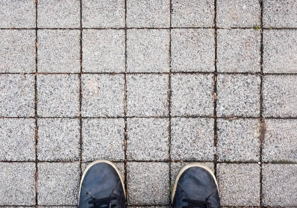 Top view on sneakers and square sidewalk