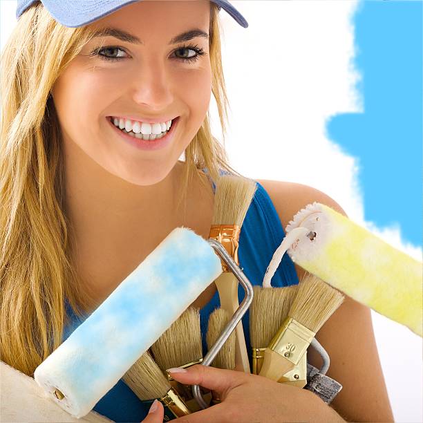 Portrait of blond girl and painting tools stock photo