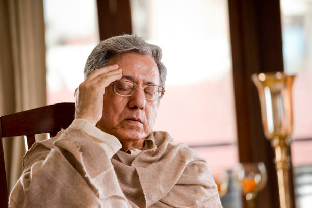 istock Senior man suffering with headache at home 1150525117