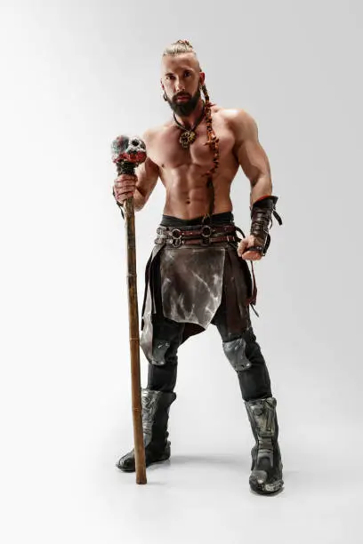 Photo of Man in leather viking's costume isolated on white studio background