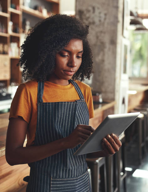 istock Female owner using digital tablet at the coffee shop 1150526982