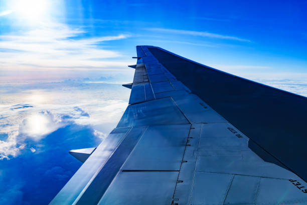 istock Clouds and sky and wing as seen through window of an aircraft 1150527926