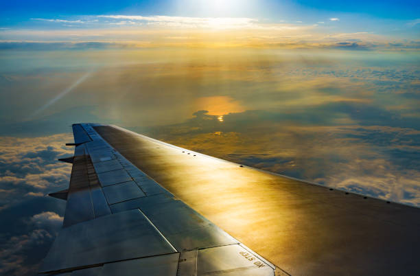istock Clouds and sky and wing as seen through window of an aircraft 1150527927