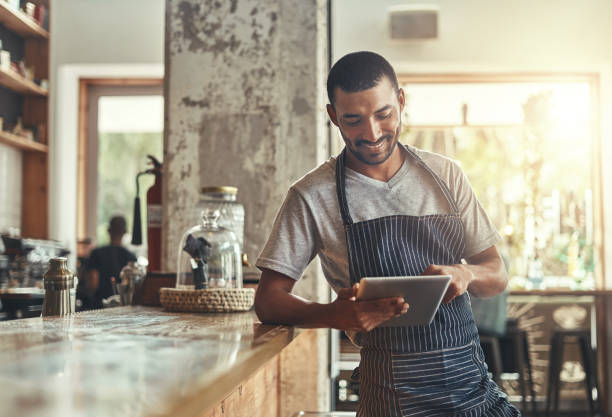 istock Young african entrepreneur using digital tablet in his cafe 1150528180