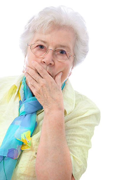 istock Senior woman with surprised expression and hand over mouth 115052843