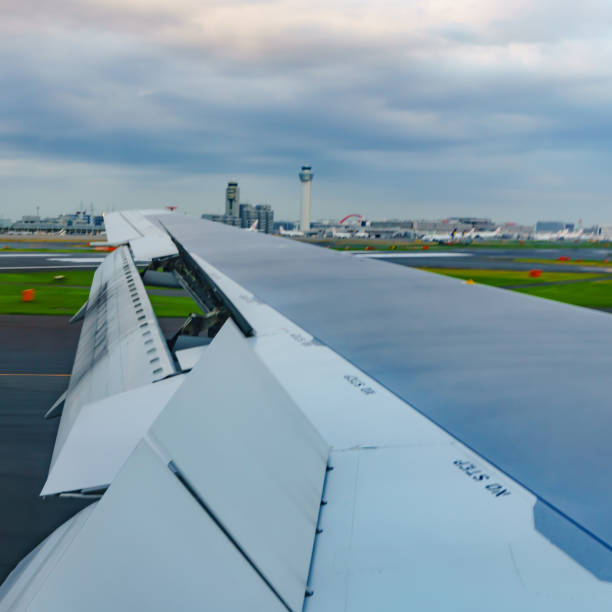 istock Clouds and sky and wing as seen through window of an aircraft 1150528636