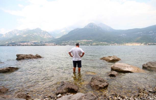 istock man looking at view of Lake Como Italy 1150530255