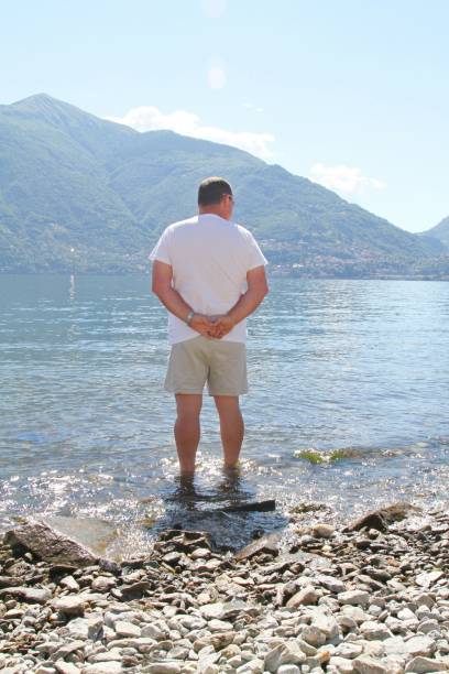 istock man looking at view of Lake Como Italy 1150530311