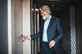 Caucasian businessman using a keyless entry card to enter his hotel room