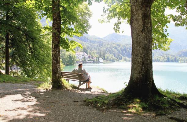 istock mature man relaxing by alpine lake 1150530378