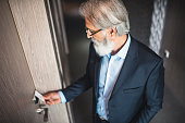 Caucasian businessman using a keyless entry card to enter his hotel room