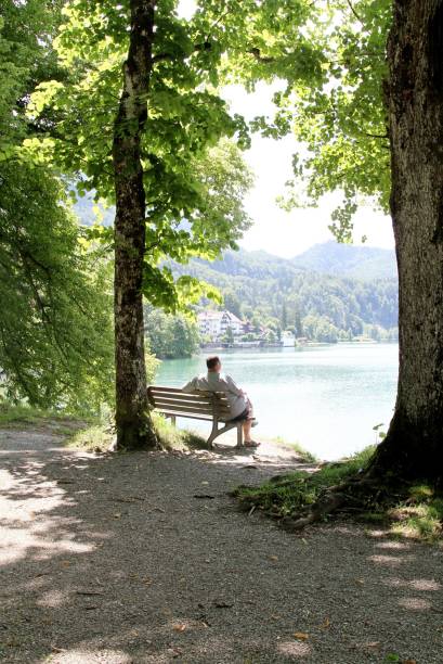 istock mature man relaxing by alpine lake 1150530451