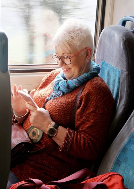 istock mature woman texting on train 1150530642