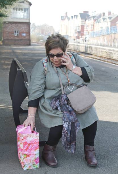 istock mature woman waiting at train station 1150530664