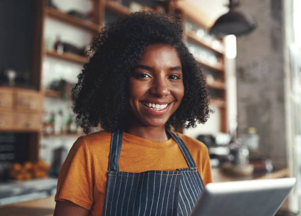 istock Happy young woman standing in her cafe 1150532170