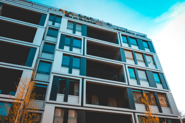 istock frog perspective of apartment house with orange tree 1150532187