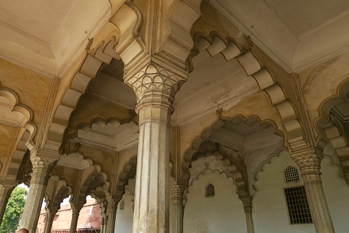 Stock photo showing traditional Indian Mughal architecture, historic ornate stone temple arches and ridged fluted pillars columns photo, cinquefoil arch / multifoil archway, Agra Fort, Uttar Pradesh, India