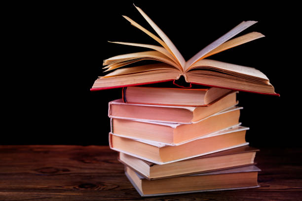 istock Stack of books on a wooden table 1150533983