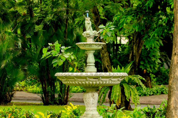 Old white fountain in the park Is a popular device for garden decoration