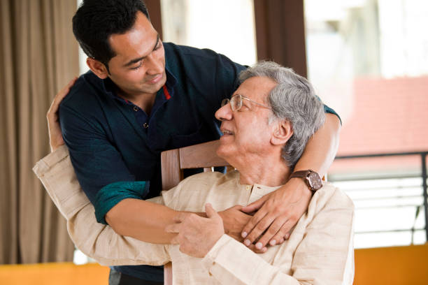 Man spending time with his father at home Man spending time with his father at home home care for the elderly stock pictures, royalty-free photos & images