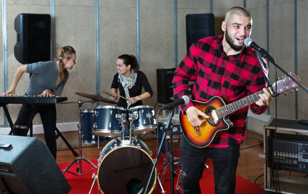 istock Bearded guy soloist playing guitar in studio 1150538808