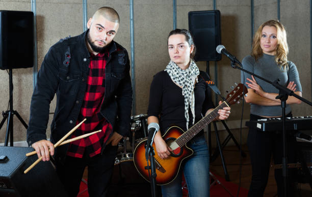 istock group of rock musicians posing with instruments 1150538820