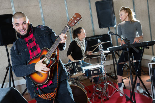 istock Bearded guy soloist playing guitar in studio 1150538829