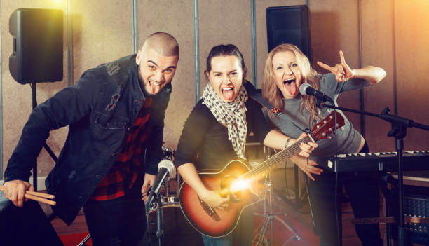 istock Three bandmates posing together with musical instruments in rehe 1150538841