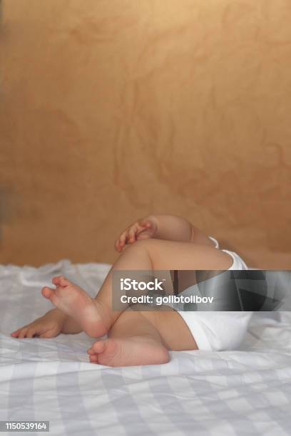 68 Month Old Baby Boy Lying Playfully In Bed Stock Photo - Download Image Now - 0-11 Months, 6-11 Months, Arm