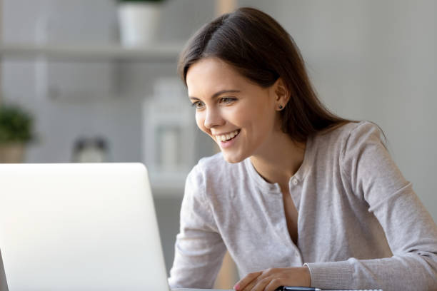 istock Happy woman reading pleasant e-mail looking on computer screen 1150540172
