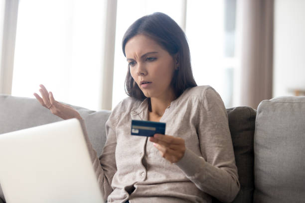 istock Woman using online banking having problem with blocked credit card 1150540192