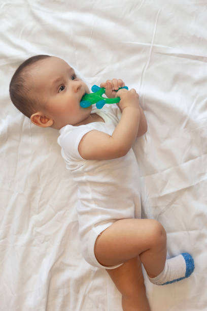 istock 6-8 month old baby boy lying playfully in bed 1150540458