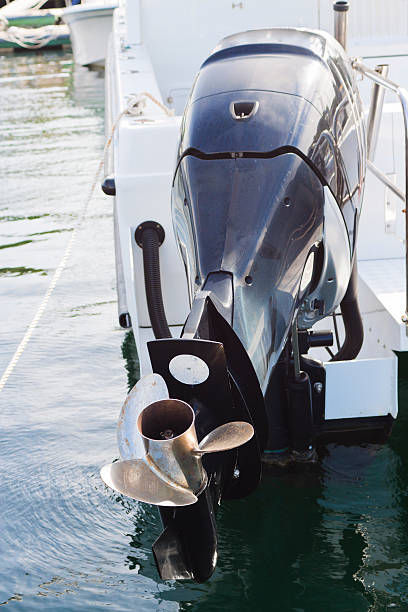 Closeup attached Boat engine with propeller attached on motorboat in marina, full frame horizontal composition