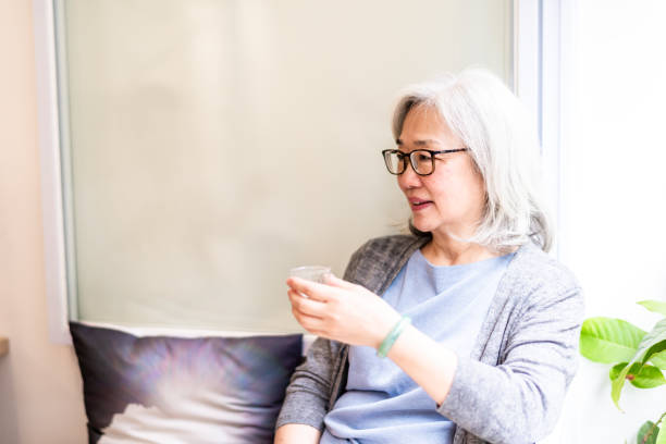 istock Elderly Asian woman is drinking tea 1150541362