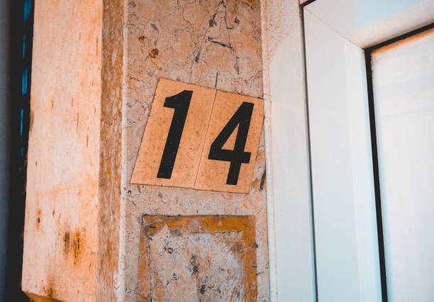 istock number 14 door sign on marble facade 1150543158