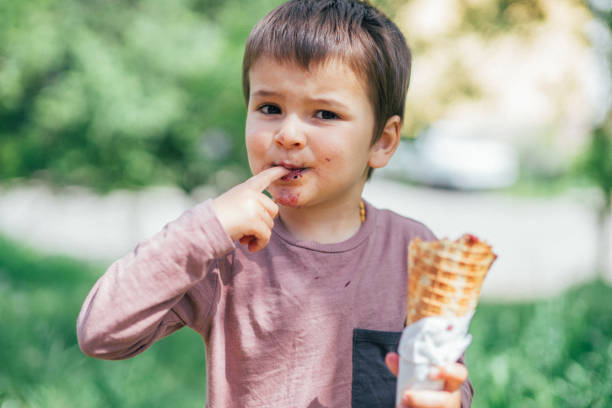 istock A cute boy eating a waffle ice cream cone 1150546047