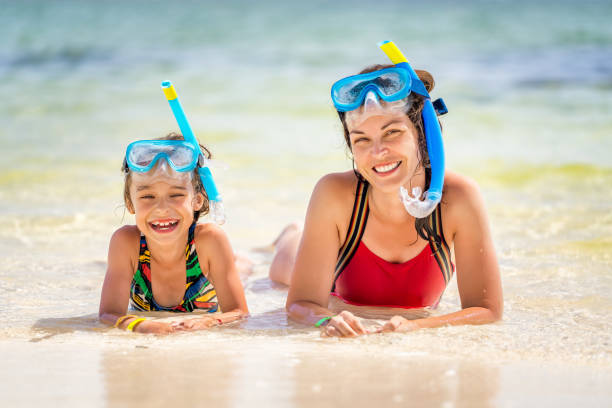 Young mother and little daughter enjoying the beach in Dominican Republic Young mother and little daughter in snorkeling masks enjoing the beach in Dominican Republic punta cana women stock pictures, royalty-free photos & images